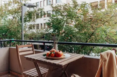 a wooden table with a bowl of fruit on a balcony at Casa Central in Barcelona