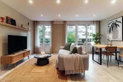 a living room with a couch and a tv at Casa Central in Barcelona