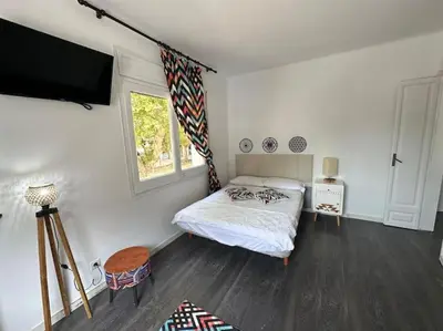 a bedroom with a bed and a flat screen tv at Casa Vallromanes Rest House in Vallromanas