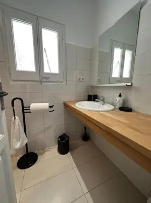 a bathroom with a sink and a mirror at Casa Vallromanes Rest House in Vallromanas