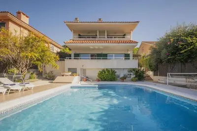 a large swimming pool in front of a house at Villa Sitges Cambera 10 minutos de Playa andando Muy Comoda Area Tranquila in Sitges
