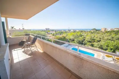 a balcony with a view of a swimming pool at Villa Sitges Cambera 10 minutos de Playa andando Muy Comoda Area Tranquila in Sitges