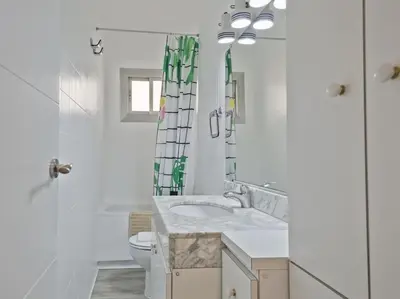 a white bathroom with a sink and a toilet at Winahost Barcelona Diagonal in Barcelona