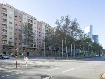 an empty street in front of a large building at Winahost Barcelona Diagonal in Barcelona