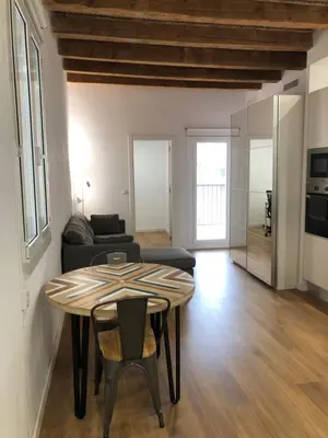 a living room with a table and a couch at Charming modern flat in Barcelona in Barcelona