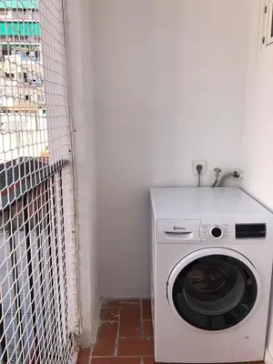 a washing machine in a corner of a room at Charming modern flat in Barcelona in Barcelona