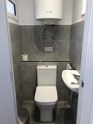 a small bathroom with a toilet and a sink at Charming modern flat in Barcelona in Barcelona