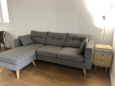 a living room with a gray couch and a table at Charming modern flat in Barcelona in Barcelona