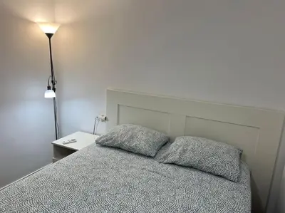 a bedroom with a bed with two pillows on it at Cozy apartment close to the beach for 2 persons in Gavà