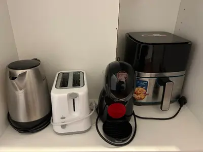 a kitchen counter with a coffee maker and a toaster at Cozy apartment close to the beach for 2 persons in Gavà