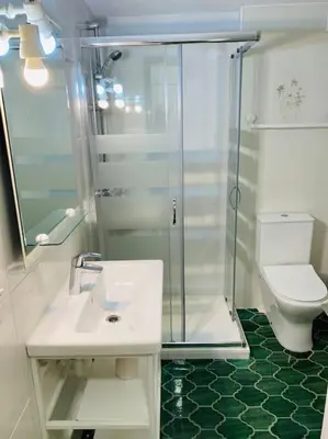 a bathroom with a shower and a sink and a toilet at Cozy apartment close to the beach for 2 persons in Gavà