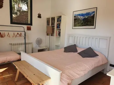 a bedroom with a bed and a table in it at Tranquilidad cerca de Barcelona in Molins de Rei
