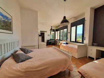 a large bedroom with two beds and windows at Tranquilidad cerca de Barcelona in Molins de Rei