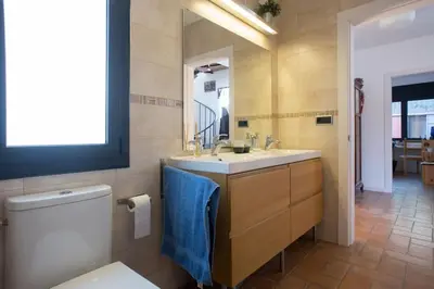 a bathroom with a toilet and a sink and a mirror at Tranquilidad cerca de Barcelona in Molins de Rei