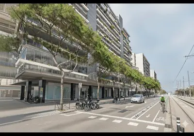 a street with a building with motorcycles parked on the street at CCIB Forum Deluxe Apartment in Sant Adria de Besos