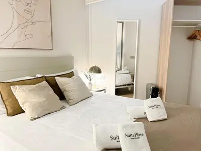 a bedroom with a white bed with two towels on it at Eixample Apart Sagrada Familia 52 in Barcelona