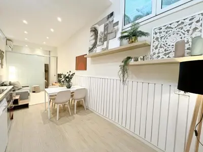 a kitchen and dining room with a table and chairs at Eixample Apart Sagrada Familia 52 in Barcelona