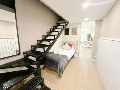 a room with a staircase and a bed in it at Eixample Apart Sagrada Familia 52 in Barcelona