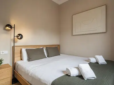 a bedroom with a bed with two towels on it at Sagrada Familia's View 3B1 5Bath in Barcelona