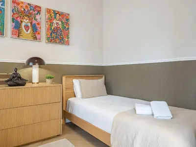 a bedroom with two beds and a dresser with towels at Sagrada Familia's View 3B1 5Bath in Barcelona