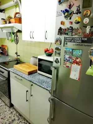 a kitchen with a refrigerator and a microwave at Habitación doble exterior en piso compartido in Sant Cugat del Vallès