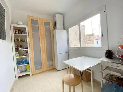 a sunset with a kite flying in the sky at Double room with inside window in shared apartment in Barcelona