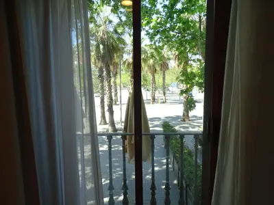 a window with a view of the palm trees at The Hotel 592 - Adults Only in Barcelona