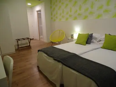 a bedroom with a large bed with green pillows at The Hotel 592 - Adults Only in Barcelona
