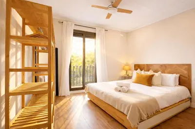 a bedroom with a bed and a wooden ladder at Boutique Casanova in Barcelona