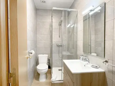 a bathroom with a shower and a toilet and a sink at Boutique Casanova in Barcelona