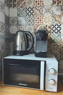 a microwave with a coffee pot on top of it at Zona Camp Nou 15 minutos centro en metro in Hospitalet de Llobregat