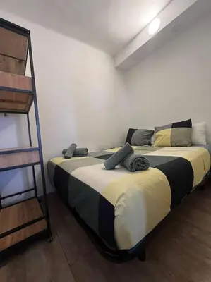 a bedroom with a bed and a bunk ladder at Zona Camp Nou 15 minutos centro en metro in Hospitalet de Llobregat