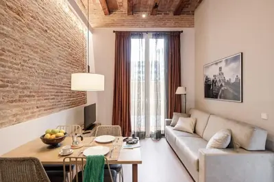 a living room with a couch and a table at Pau Claris Double - Home next to Paseo de Gracia in Barcelona