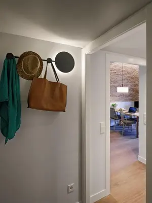 a hallway with a purse hanging on a wall at Pau Claris Double - Home next to Paseo de Gracia in Barcelona