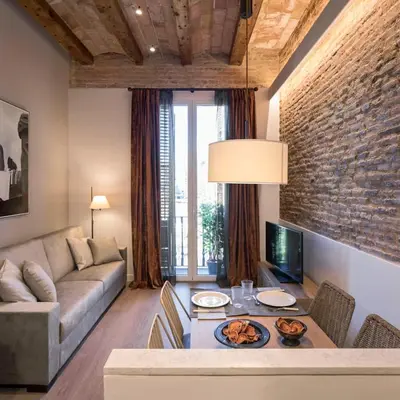 a living room with a couch and a table at Pau Claris - Design apt next to Paseo de Gracia in Barcelona