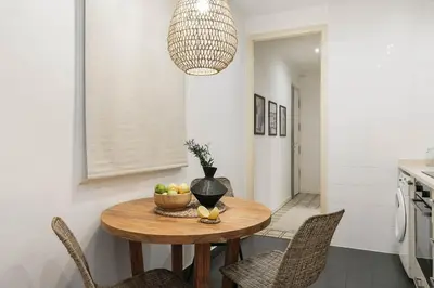 a living room with a couch and a large plant at Veduto - 2 bedrooms in Eixample Esquerra in Barcelona