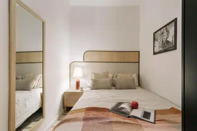 a bedroom with a bed with a black cabinet at Veduto - 2 bedrooms in Eixample Esquerra in Barcelona