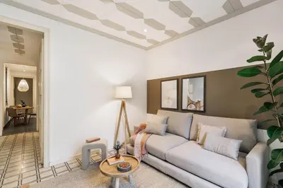 a living room with a couch and a table at Veduto - 2 bedrooms in Eixample Esquerra in Barcelona