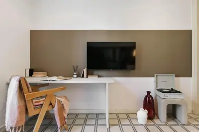 a living room with a couch and a table at Veduto - 2 bedrooms in Eixample Esquerra in Barcelona