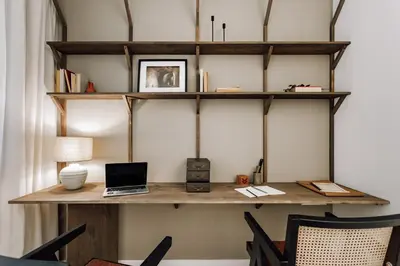 a room with a desk with a laptop on a shelf at Botijo - 2 bedrooms in Eixample Esquerra in Barcelona