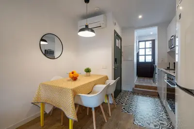 a kitchen and dining room with a table and chairs at Ola Living Batlló in Barcelona