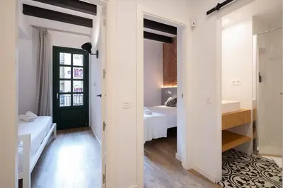 a small room with two beds and a doorway at Ola Living Batlló in Barcelona