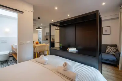 a bedroom with a large bed with two towels at Ola Living Batlló in Barcelona