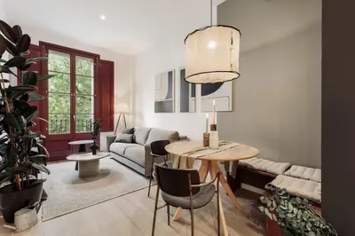 a living room with a table and a plant at Brisa - 1 bedroom and balcony in Sant Antoni in Barcelona