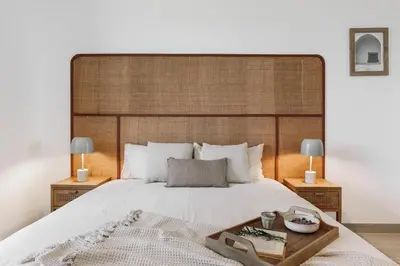 a kitchen with wooden cabinets and a stainless steel refrigerator at Sole - 2 bedrooms in Poblenou in Barcelona