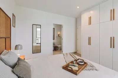 a dining room table with chairs and a vase on it at Sole - 2 bedrooms in Poblenou in Barcelona