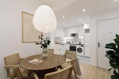 a white bedroom with a large bed and a window at Praiano - 2 bedrooms, balcony and terrace in Ciutat Vella in Barcelona