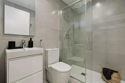 a kitchen with white cabinets and a washer and dryer at Praiano - 2 bedrooms, balcony and terrace in Ciutat Vella in Barcelona