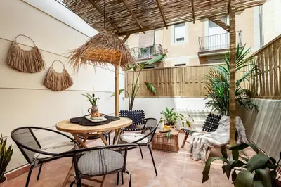 a patio with a table and chairs and a balcony at Bintan - 1 bedroom and terrace in Gràcia in Barcelona