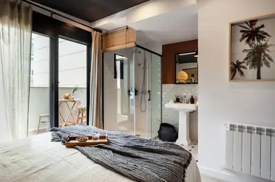 a table with a plant and a book and a vase at Bintan - 1 bedroom and terrace in Gràcia in Barcelona
